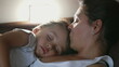 © Marco - Mother and child napping together lying on couch. Candid authentic parent asleep with son