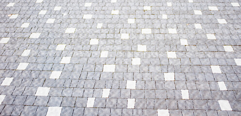 Wall Mural - Abstract background of cobblestone pavement close-up