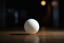  A White Egg Sitting On Top Of A Wooden Table Next To A Light Bulb In The Dark Room Of A House Or Office Building,.  Generative Ai