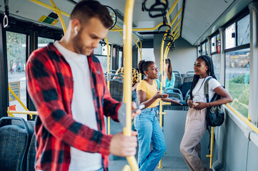 Poster - Two african american woman riding together in a bus