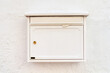 © Pixel-Shot - View of mailbox on white building wall