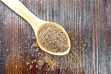 Wall Mural - Cumin seeds in spoon on board top