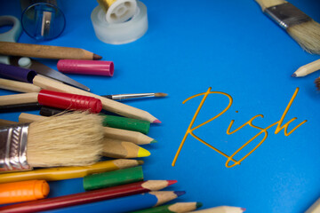 Poster - Overhead shot of school supplies with Risk text. Brushes, pencils, artistic tools. Art And Craft Work Tools.