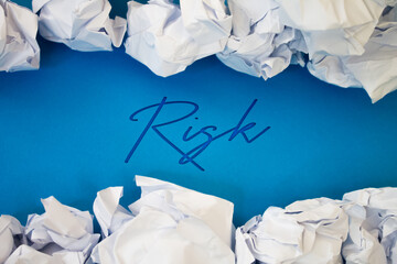 Poster - Risk text with Torn, Crumpled White Paper on colored background.