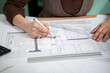 © DC Studio - Details shot of architect blueprints on a desk. Business and creativity. Architecture job