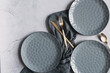 © mashiki - set of grey modern ceramic plates with golden cutlery. Dishware trendy  collection.