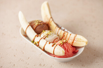 Wall Mural - Delicious sweet banana split ice cream dessert with caramel syrup or topping and cherry.