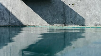 Wall Mural - water wave of blue swimming pool on cement wall, construction industry