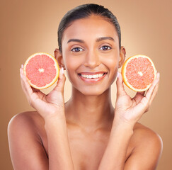 Skincare, woman smile portrait and grapefruit for health, wellness and beauty of a young model with happiness. Studio, detox and healthy fruit with vitamin c and nutrition for facial and dermatology