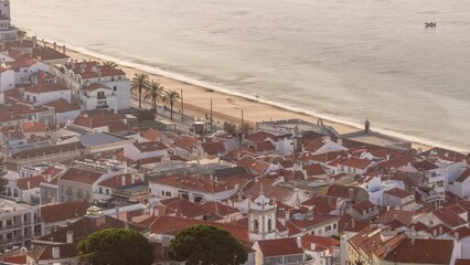 Wall Mural - Aerial view of the coastline of the village of Sesimbra timelapse with fortress, in the middle of the Atlantic Ocean during sunrise. Morning light on typical houses from the Castle viewpoint. Portugal