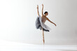 © Lustre Art Group  - Young and incredibly beautiful ballerina is posing and dancing in a white studio. Classical ballet art
