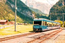 Passenger Train In Countryside Landscape In Switzerland