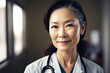 Portrait of a middle aged asian woman doctor smiling
