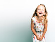 © Steffen Kögler - cute blonde girl or child laughs happily and happily against a white background - space for text - theme childhood or childrenr - Generative AI