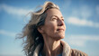 © nenetus - Beautiful mature woman looking for the horizon while relaxing in nature. Generative AI
