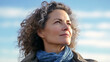 © nenetus - Beautiful mature woman looking for the horizon while relaxing in nature. Generative AI