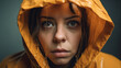 © nenetus - Pensive girl looking at the camera in a raincoat while rainwater falls on her. Generative AI