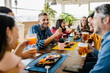 © Xavier Lorenzo - Multi-ethnic group of young student friends having lunch drinking and eating together in coffee shop - Happy people, food and beverage concept