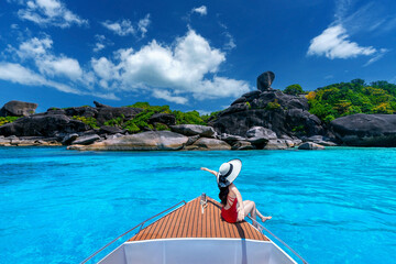 Wall Mural - Female in bikini relaxing on yacht. Similan island in Thailand.