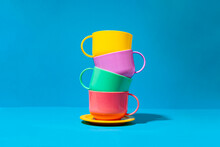 Multicolored Ceramic Cups On Blue Background