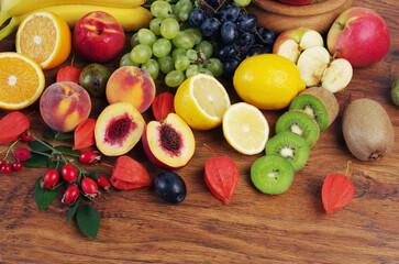  A variety of fruits on a wooden table.