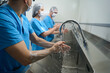 © Svitlana - Men and women thoroughly wash their hands before the operation