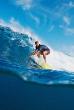 Surfer Rides The Wave. Exited Man Surfs The Ocean Wave In The Maldives, Splitted Underwater View