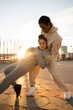 © Alba Vitta/Stocksy - Portrait of man holding woman who is falling