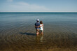 © Maria Manco/Stocksy - Children hug in waters of Lake Michigan