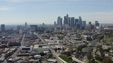 2022 - Excellent Aerial Footage Of Cars Driving Away From Downtown Los Angeles.