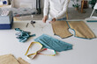 © Oleksii Syrotkin/Stocksy - Seamstress workplace. Pattern. Fashion industry. Fabric. Business
