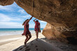 © Luis Herrera/Stocksy - two travel woman exploring nature at the beach