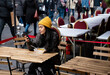 © Hernandez & Sorokina/Stocksy - Woman Using Smartphone At Restaurant Terrace