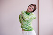© Viktor Solomin/Stocksy - Young woman hugs herself on white background
