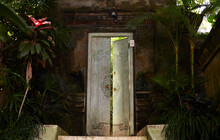 Closeup Southeast Asian Style Wooden Door With A Garden Background