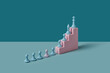 © Yaroslav Danylchenko/Stocksy - Pastel-colored chess pieces on paper stairs.