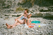 © Sergey Narevskih/Stocksy - Mother and daughter sunbathing on beach, film ugc