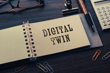 Poster - There is a notebook with the word Digital Twin. It is eye-catching image.