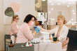 © Alina Hvostikova/Stocksy - Professional manicurists giving manicure to clients