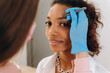 © Alina Hvostikova/Stocksy - Crop beautician plucking eyebrows with tweezers