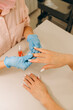 © Alina Hvostikova/Stocksy - Crop manicurist applying nail serum on fingernail