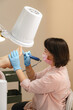 © Alina Hvostikova/Stocksy - Beautician doing procedure on clients feet