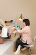 © Alina Hvostikova/Stocksy - Beautician doing procedure on clients feet