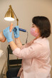 © Alina Hvostikova/Stocksy - Beautician doing procedure on clients feet