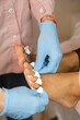 © Alina Hvostikova/Stocksy - Crop beautician putting on toe separators
