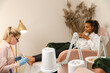 © Alina Hvostikova/Stocksy - Happy client during pedicure in beauty salon