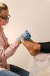 © Alina Hvostikova/Stocksy - Crop beautician doing relaxing massage on foot