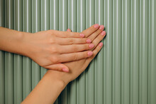 Crop female hands with pink manicure
