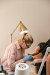 © Alina Hvostikova/Stocksy - Crop pedicurist applying nail polish