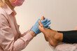 © Alina Hvostikova/Stocksy - Crop beautician doing relaxing massage on foot